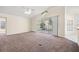 Spacious living room with neutral carpet and large sliding doors leading to an outdoor space at 13491 Coronado Dr, Spring Hill, FL 34609