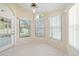 Bright sunroom featuring tile floors, ceiling fan and multiple windows letting in natural light with a view of the outdoors at 13491 Coronado Dr, Spring Hill, FL 34609