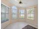 Bright sunroom with multiple windows and ceiling fan for natural light and comfort at 13491 Coronado Dr, Spring Hill, FL 34609
