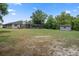 Expansive backyard with a fenced pool area and storage shed at 1376 Fayetteville Dr, Spring Hill, FL 34609