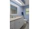 Bright bathroom featuring blue walls, a granite vanity top and tiled floor at 1376 Fayetteville Dr, Spring Hill, FL 34609