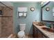Bathroom with walk in shower, double vanity with granite counters, and decorative lighthouse on the window at 1376 Fayetteville Dr, Spring Hill, FL 34609
