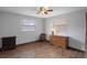 Bedroom with wood floors, two windows, ceiling fan, and dresser at 1376 Fayetteville Dr, Spring Hill, FL 34609