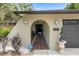 Welcoming front entrance with arched entryway, tiled walkway, and stylish outdoor lighting at 1376 Fayetteville Dr, Spring Hill, FL 34609