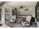 Cozy hot tub area for relaxing with chairs and ceiling fan in covered outdoor space at 1376 Fayetteville Dr, Spring Hill, FL 34609