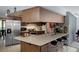 A stylish kitchen featuring an island with bar seating and stainless steel appliances at 1376 Fayetteville Dr, Spring Hill, FL 34609