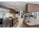The kitchen boasts stainless appliances, a breakfast bar, and an open design at 1376 Fayetteville Dr, Spring Hill, FL 34609