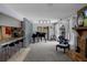 Open-concept living area with a piano, stone fireplace and access to the kitchen at 1376 Fayetteville Dr, Spring Hill, FL 34609