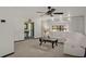 Bright living room with a comfortable white sectional, ceiling fan, and stylish decor at 1376 Fayetteville Dr, Spring Hill, FL 34609