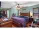 Spacious main bedroom with a wooden bed frame and blue and red blanket at 1376 Fayetteville Dr, Spring Hill, FL 34609
