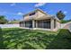 Expansive backyard featuring a screened patio offers ample space for outdoor enjoyment and relaxation at 13772 Dunwoody Dr, Spring Hill, FL 34609
