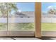 Screened in patio providing views of the backyard with a white fence for privacy and security at 13772 Dunwoody Dr, Spring Hill, FL 34609