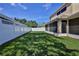 Private backyard featuring a screened patio and a white fence provides a safe and enjoyable outdoor space at 13772 Dunwoody Dr, Spring Hill, FL 34609