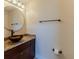 Bathroom featuring granite countertop, vessel sink, and round mirror above a dark wood vanity at 13772 Dunwoody Dr, Spring Hill, FL 34609