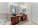 Bathroom featuring dual sinks with granite countertops and a soaking tub nearby at 13772 Dunwoody Dr, Spring Hill, FL 34609