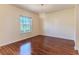 Bedroom with hardwood floors, white walls, chandelier lighting, and a large window at 13772 Dunwoody Dr, Spring Hill, FL 34609