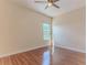 Bright bedroom featuring wood floors, a ceiling fan, and a window letting in natural light at 13772 Dunwoody Dr, Spring Hill, FL 34609