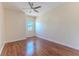 Bright bedroom featuring hardwood floors, ceiling fan, and sunlit window, ready to move in at 13772 Dunwoody Dr, Spring Hill, FL 34609