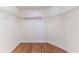 Walk-in closet with wire shelving and hardwood floors for organized storage space at 13772 Dunwoody Dr, Spring Hill, FL 34609