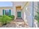 A green front door with landscaping on both sides, enhancing the home's entryway at 13772 Dunwoody Dr, Spring Hill, FL 34609
