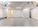 A clean, spacious garage with white walls, a water heater, and an open doorway at 13772 Dunwoody Dr, Spring Hill, FL 34609
