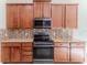 Modern kitchen features granite counters, stainless steel microwave, and range at 13772 Dunwoody Dr, Spring Hill, FL 34609