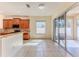 Bright kitchen features tile floors, granite countertops, wood cabinets, and sliding glass doors to the patio at 13772 Dunwoody Dr, Spring Hill, FL 34609