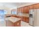 Spacious kitchen with island, granite countertops, and stainless steel refrigerator at 13772 Dunwoody Dr, Spring Hill, FL 34609