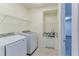 Well-lit laundry room equipped with modern washer, dryer, and sink area at 13772 Dunwoody Dr, Spring Hill, FL 34609