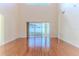 Bright living room features wood floors and sliding glass doors to the patio at 13772 Dunwoody Dr, Spring Hill, FL 34609