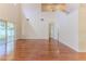 Spacious living room with soaring ceilings, wood floors, and sliding glass doors to the backyard at 13772 Dunwoody Dr, Spring Hill, FL 34609