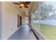 Relaxing screened patio with ceiling fans and a view of the fenced backyard provides a comfortable outdoor space at 13772 Dunwoody Dr, Spring Hill, FL 34609