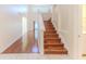 Wooden staircase with hardwood floors, white walls and lighting above at 13772 Dunwoody Dr, Spring Hill, FL 34609