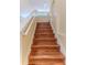 Elegant staircase featuring hardwood treads, white risers, and a decorative chandelier at 13772 Dunwoody Dr, Spring Hill, FL 34609