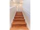 Elegant staircase featuring hardwood treads and white risers, leading to an upper floor at 13772 Dunwoody Dr, Spring Hill, FL 34609