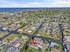 Aerial view of waterfront home with boat dock access, showcasing the community's canal system and neighborhood at 13821 Judy Ave, Hudson, FL 34667