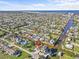 Wide aerial view of waterfront community with boat docks, canal access, and views of ocean and the surrounding neighborhood at 13821 Judy Ave, Hudson, FL 34667