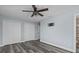 Comfortable bedroom showcases wood-look floors, a ceiling fan, TV mount, and closet space at 13821 Judy Ave, Hudson, FL 34667