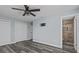 Inviting bedroom features wood-look floors, a modern fan, closet, and an ensuite bathroom at 13821 Judy Ave, Hudson, FL 34667