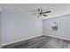 Serene bedroom featuring wood-look floors, a ceiling fan, and natural light from the window at 13821 Judy Ave, Hudson, FL 34667