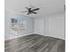 Charming bedroom with wood-look flooring, a modern fan, and double door closet at 13821 Judy Ave, Hudson, FL 34667
