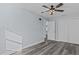 Stylish bedroom with wood-look flooring, a ceiling fan, a closet, and a tv mount at 13821 Judy Ave, Hudson, FL 34667