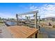 Private wooden dock with a boat lift offering waterfront access and endless nautical adventures at 13821 Judy Ave, Hudson, FL 34667