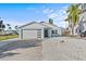 Charming single-Gathering home showcasing a modern garage door, quaint front door, and freshly painted exterior at 13821 Judy Ave, Hudson, FL 34667