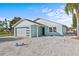 Charming single-Gathering home featuring a modern garage door, quaint front door, and freshly painted exterior at 13821 Judy Ave, Hudson, FL 34667