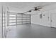 Bright garage with high ceilings, a ceiling fan, and an automatic door opener at 13821 Judy Ave, Hudson, FL 34667