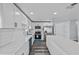 Modern kitchen featuring white cabinets, stainless steel appliances, and large island at 13821 Judy Ave, Hudson, FL 34667