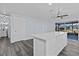 Bright and modern kitchen with island, white cabinets, and access to bathroom at 13821 Judy Ave, Hudson, FL 34667