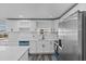 Bright kitchen featuring white cabinets and stainless steel appliances at 13821 Judy Ave, Hudson, FL 34667