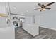 Kitchen area with island, stainless appliances, and white cabinets at 13821 Judy Ave, Hudson, FL 34667